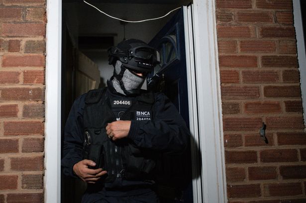 A general image of an officer carrying out a raid 