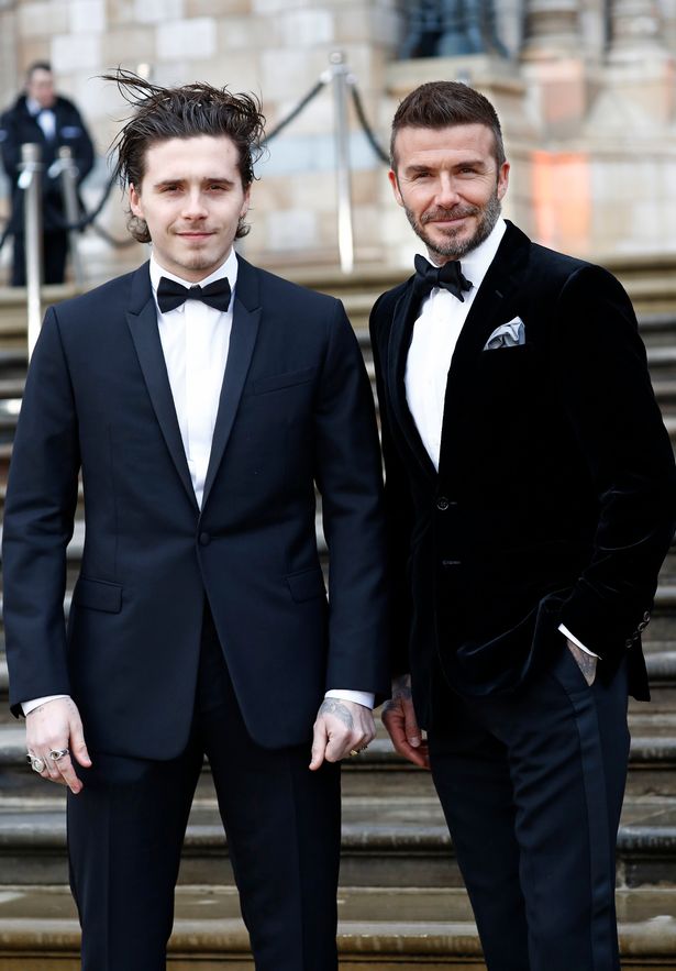 Brooklyn Beckham and David Beckham in suits 