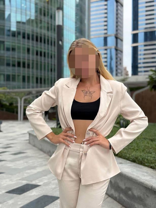 The model posing in front of buildings
