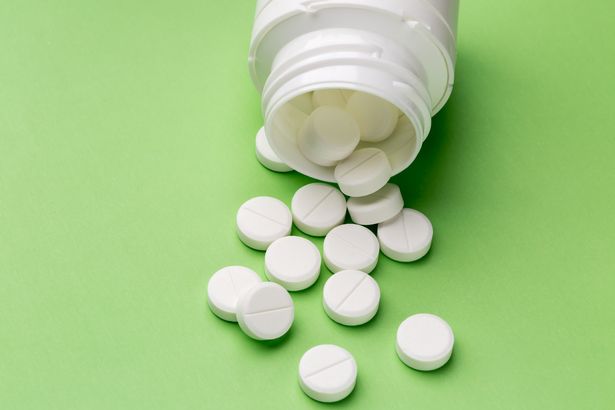 White tablets and plastic pills bottle