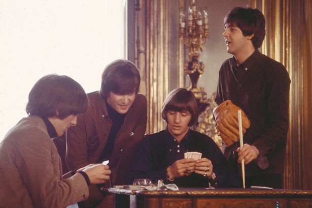 The Beatles play cards during a scene from the film 'Help!'
