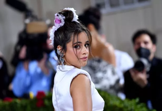 Camila Cabello in a white top.
