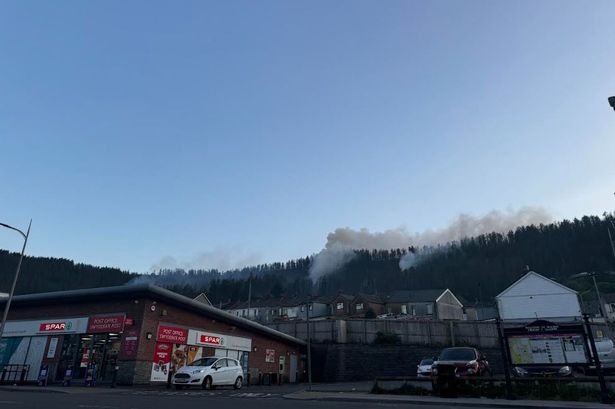 Smoke coming from a mountain above a town 