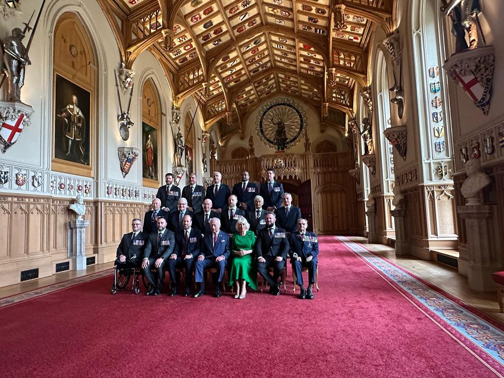 The King, Queen and Prince William posing in a formal photo at a reception at Windsor Castle