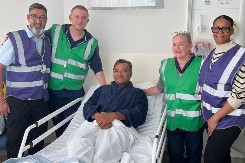 Dr Pankaj Kumar who works at Sandwell and West Birmingham NHS Trust but was being treated for pneumonia was the last patient to be transferred from City Hospital to Midland Met (with staff from the new hospital also pictured)