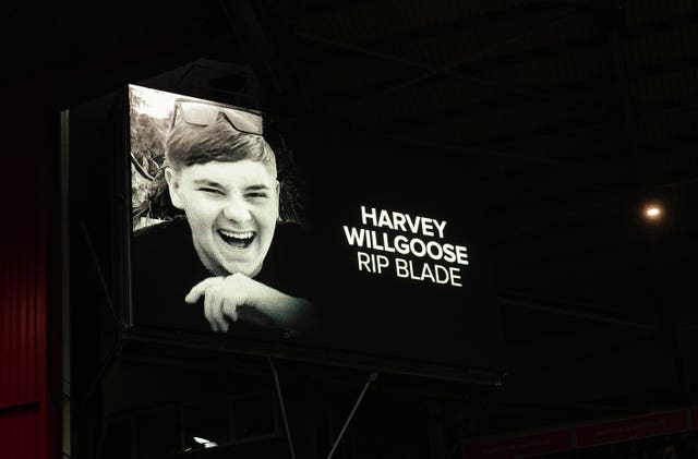 A tribute to Harvey Willgoose is shown on screens at the stadium