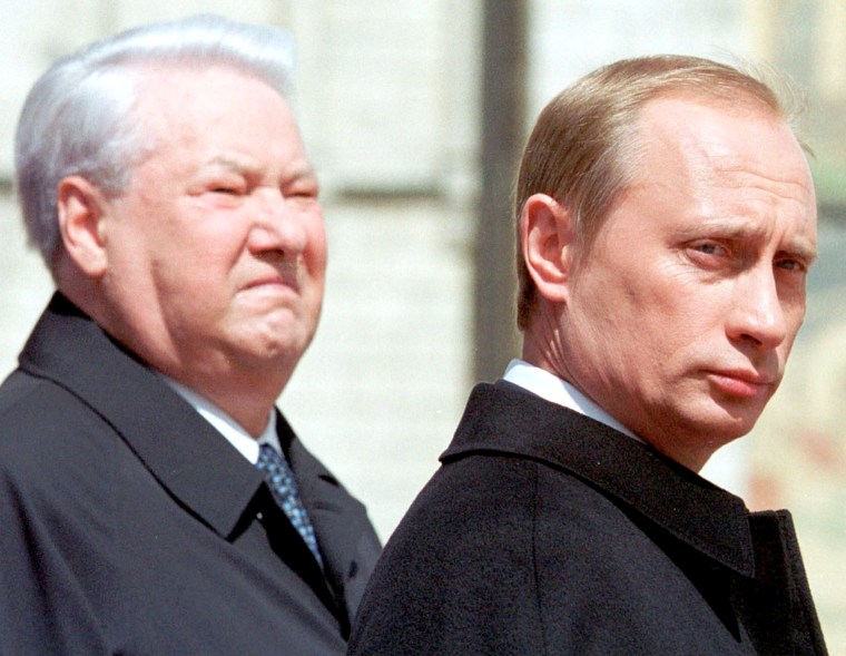 Boris Yeltsin stands with Vladimir Putin in Moscow, 2000