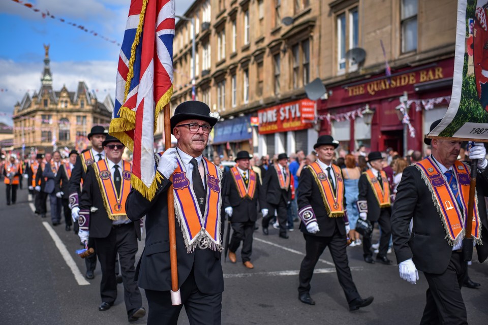 Orange Order members marching in a parade.