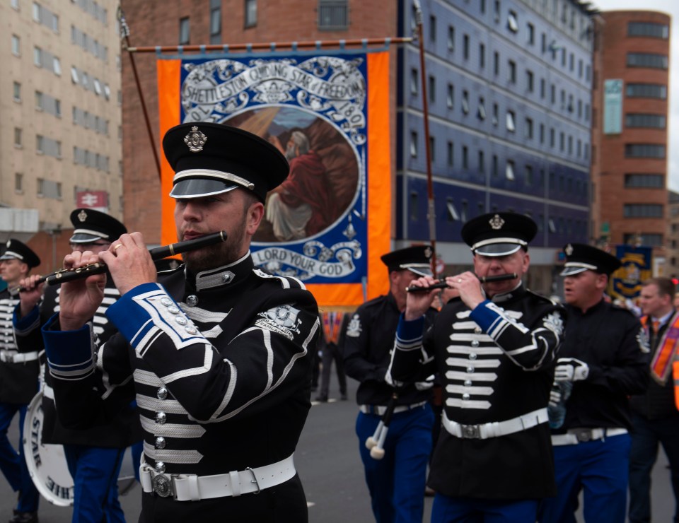 Orange order marching band in Glasgow playing flutes.