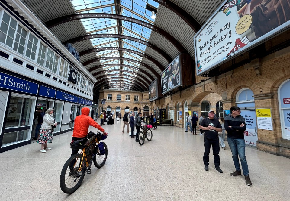 Tourists and cyclists in York Station.