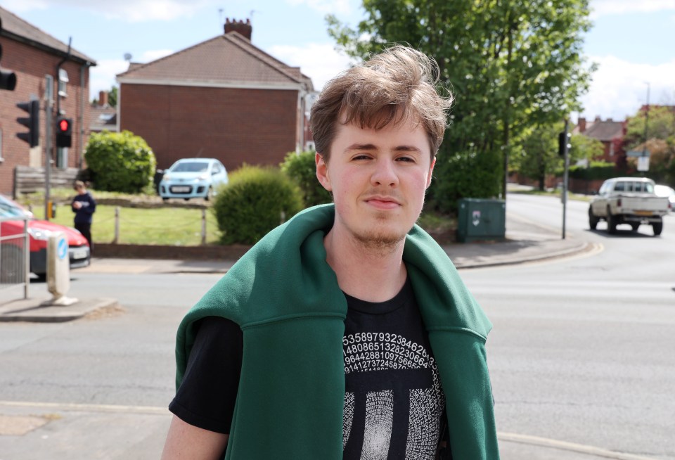 Portrait of a young man standing on a city street.