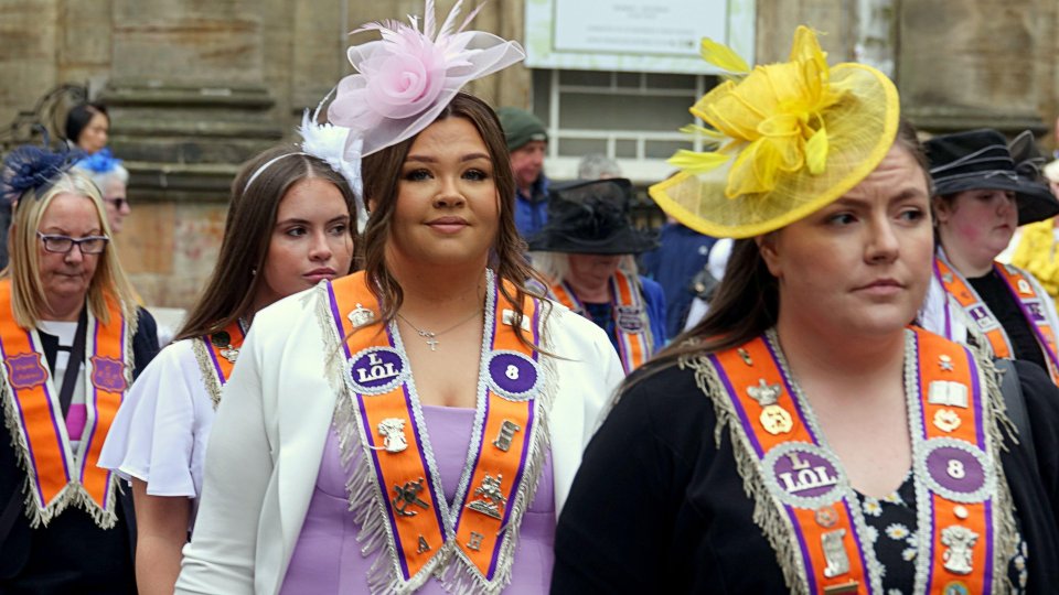 Five hundred women in orange sashes march in Glasgow.