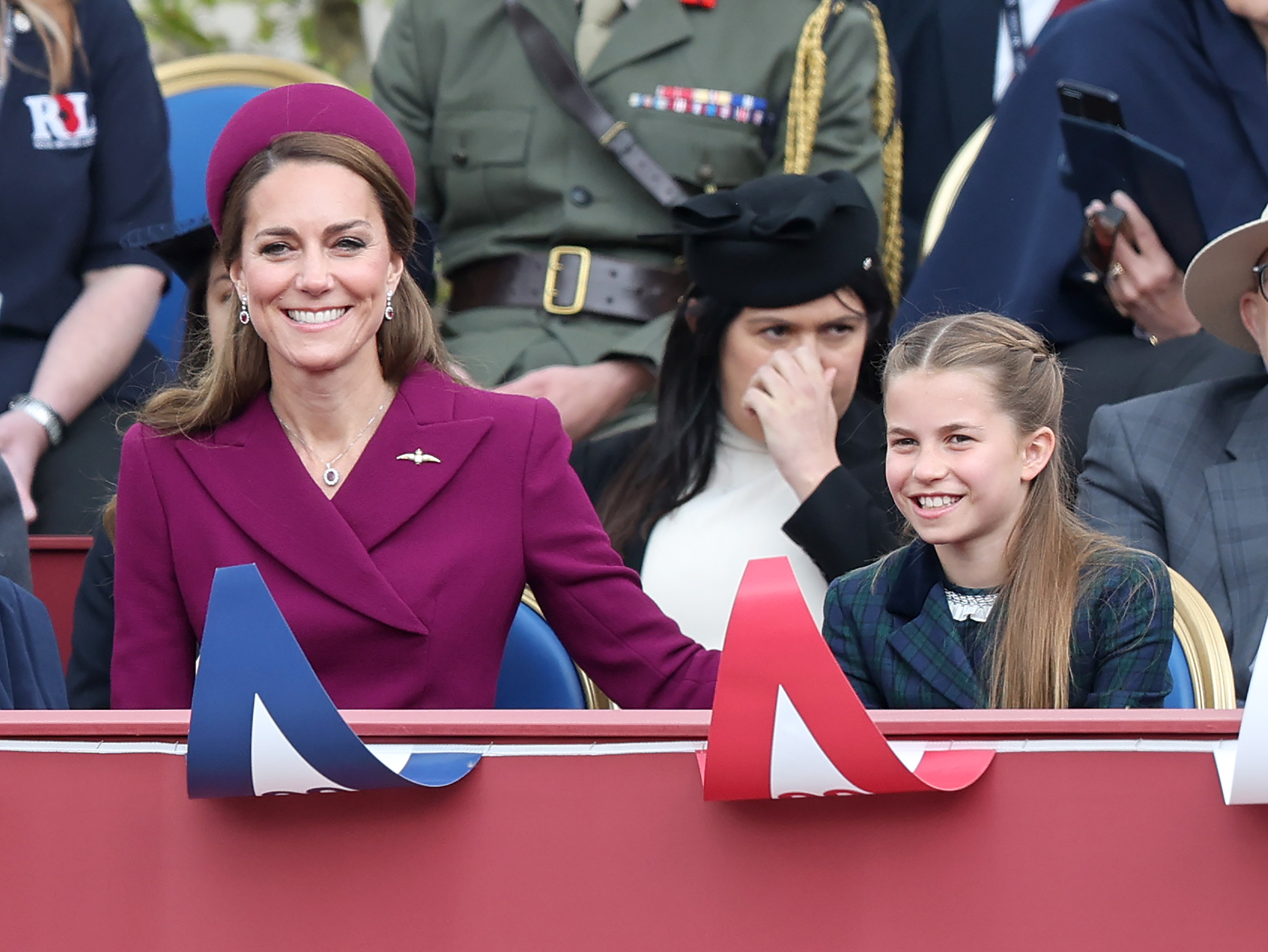 Catherine, Princess of Wales and Princess Charlotte of Wales watch the military procession.