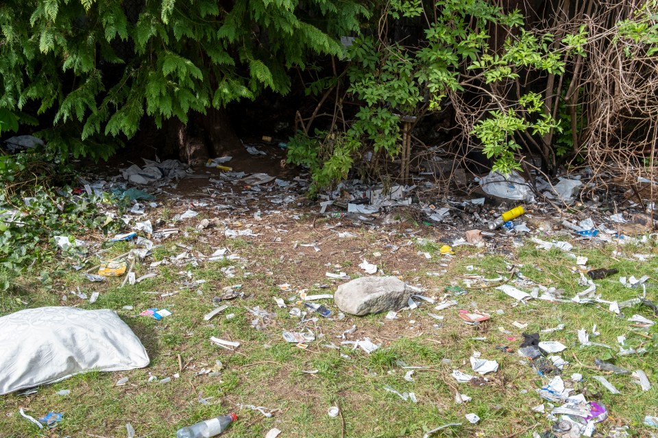 Litter and drug paraphernalia scattered on the ground.