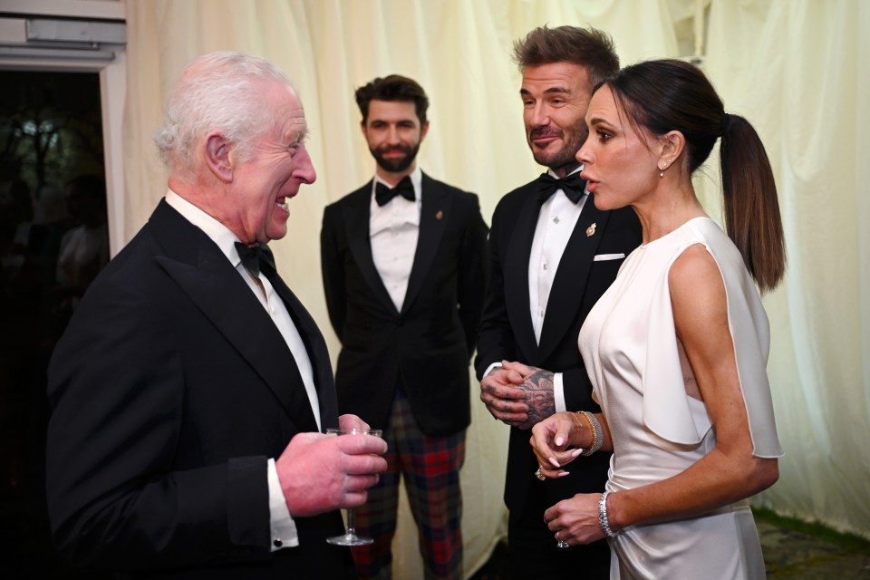 King Charles III speaks with David and Victoria Beckham at a dinner.