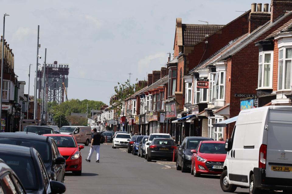 Parliament Road in Middlesbrough, showing shops and parked cars.