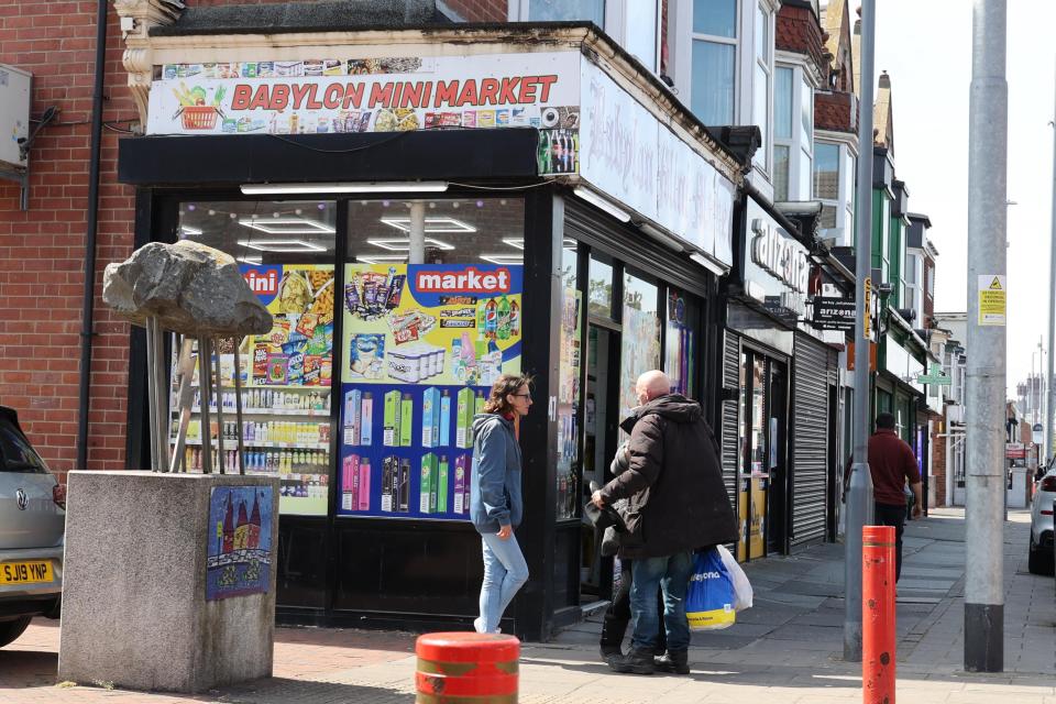 Middlesbrough high street scene showing a mini-market and other shops.