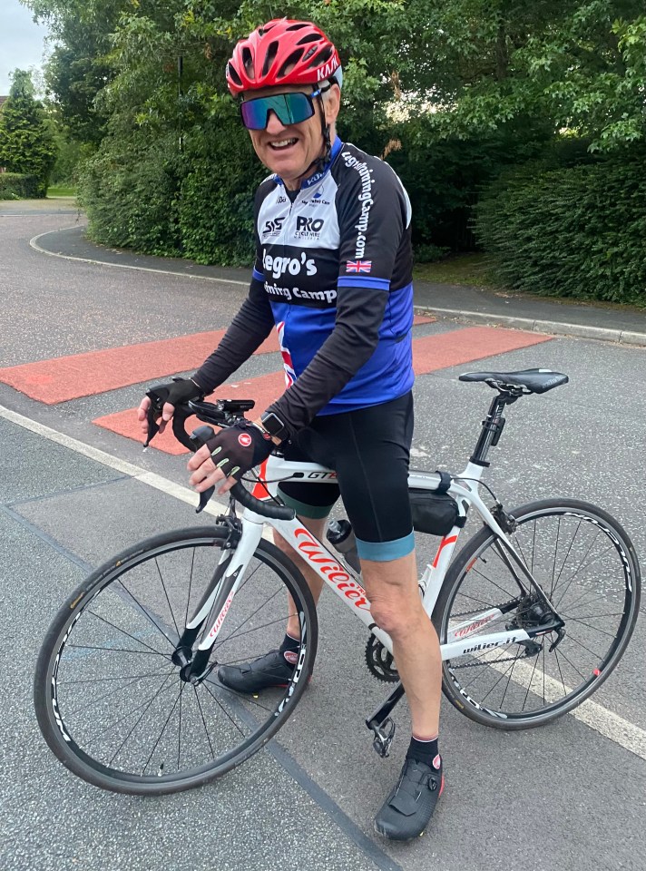 Man standing with his bicycle.