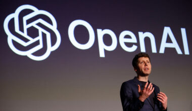 Sam Altman, CEO of OpenAI, speaks during a news conference with the OpenAI logo on a screen behind him.