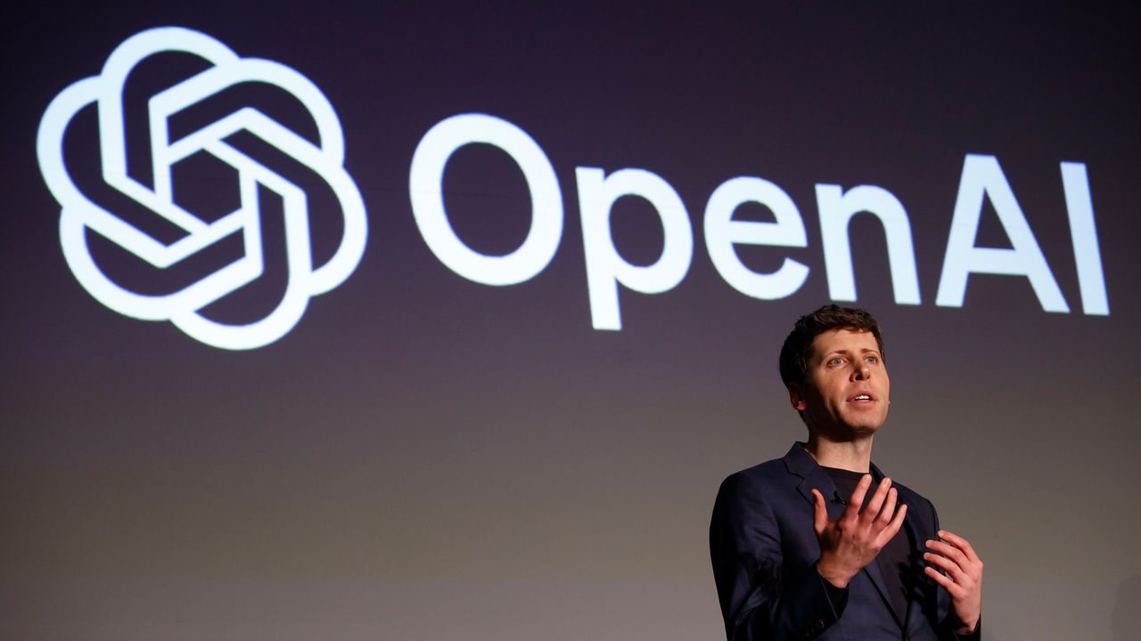 Sam Altman, CEO of OpenAI, speaks during a news conference with the OpenAI logo on a screen behind him.