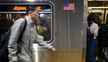 Commuters wait for a delayed Path Transit line to depart during rush hour at 33rd Street in New York City, USA.