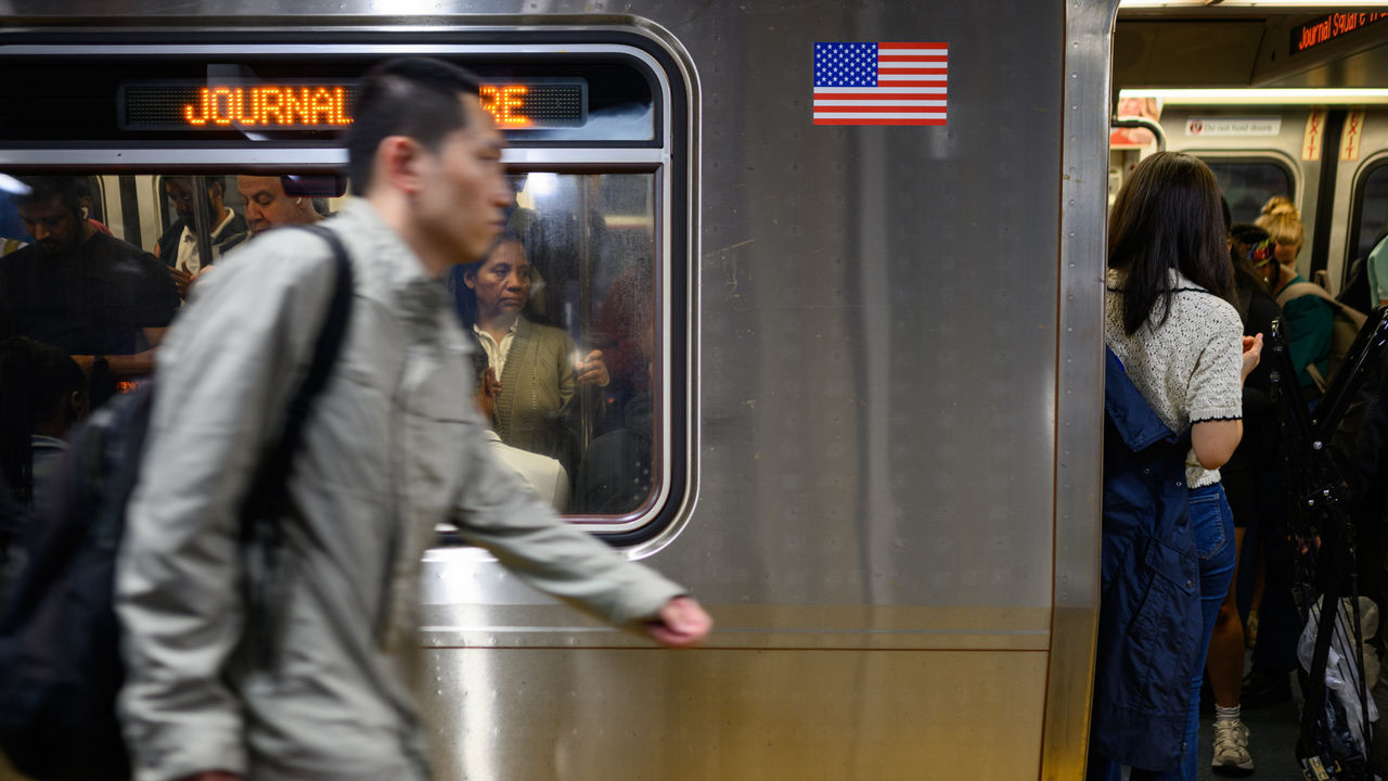 Commuters wait for a delayed Path Transit line to depart during rush hour at 33rd Street in New York City, USA.