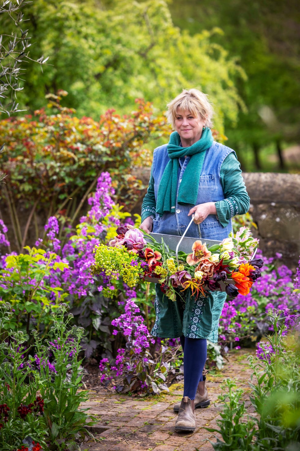 sarah raven carrying zinc harvesting trug with tulips, euphorbia and fritillaries