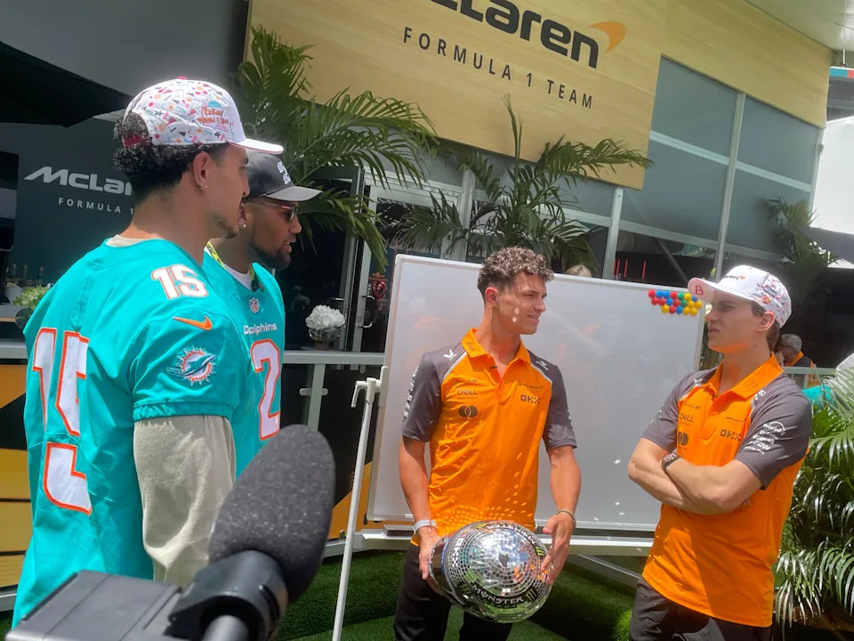 Miami Dolphins players Jaelan Phillips (left) and Bradley Chubb chat with McLaren drivers Lando Norris and Oscar Piastri on May 1, 2025.