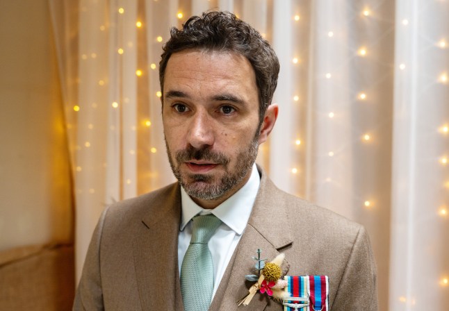 John Sugden looking panicked in his wedding suit in Emmerdale.