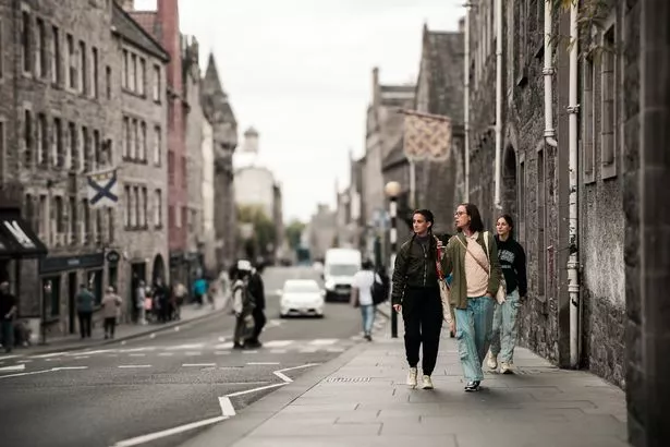 A picture of three woman walking together the Royal Mile in Edinburgh