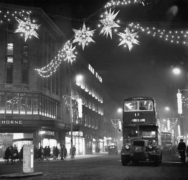 Christmas lights of shimmering stars hang over Lord Street near the corner of Whitechapel, Liverpool. Horne's department store to the left. November 25, 1962