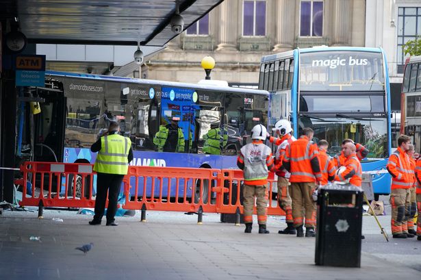 Emergency services at the scene of a bus crash at the City Tower building close to Manchester's Piccadilly Gardens Metrolink stop