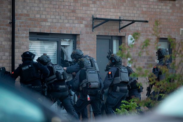 Armed cops during the raid on Friday