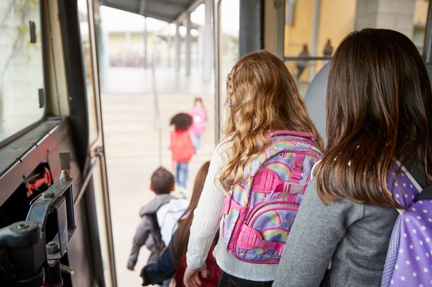 Stock image of schoolchildren getting off bus