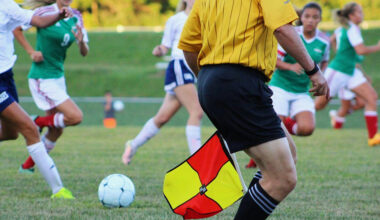 A photo of two women's teams playing a football match.