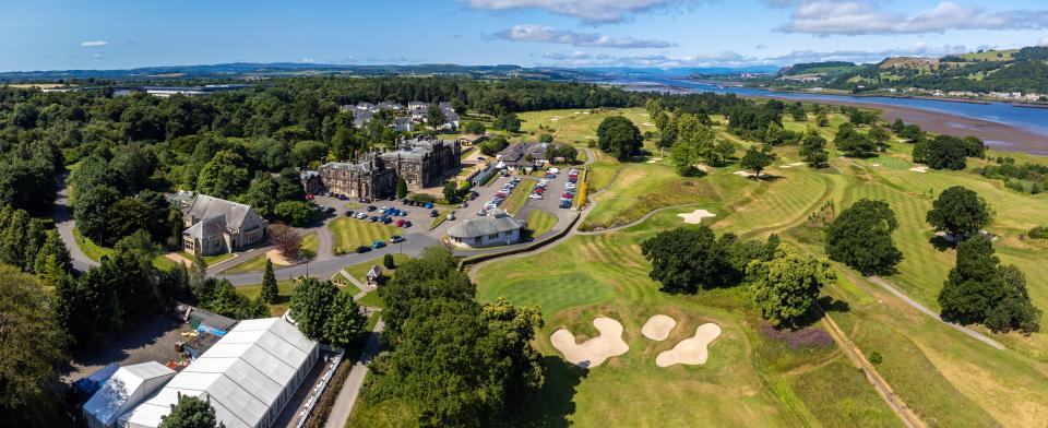 Aerial view of a golf course by a river.