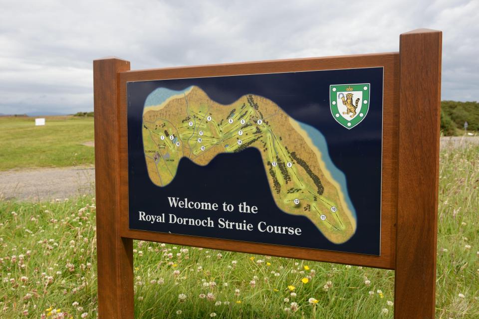 Welcome sign for the Royal Dornoch Struie golf course, showing a course map.
