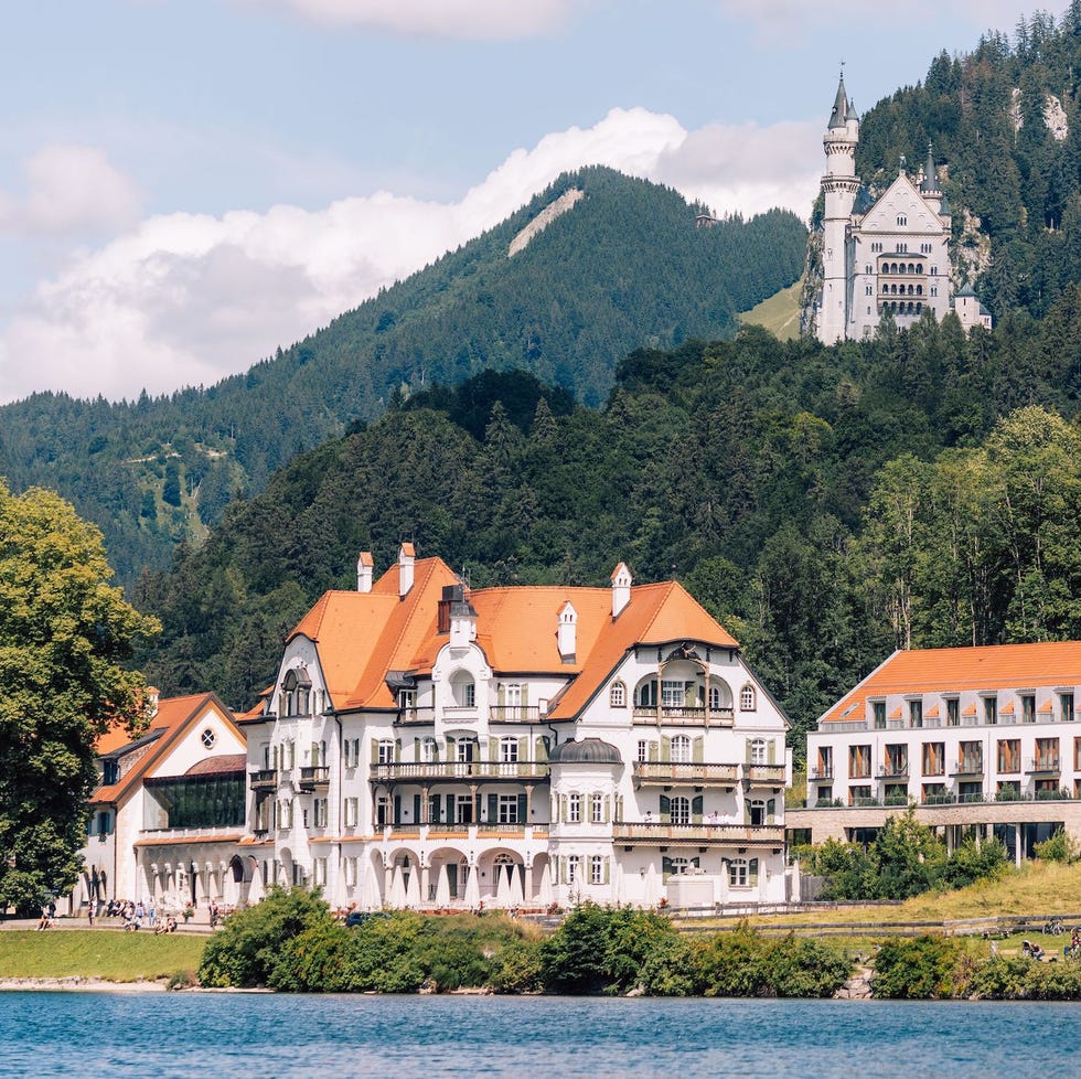 a large building with a tower by a body of water