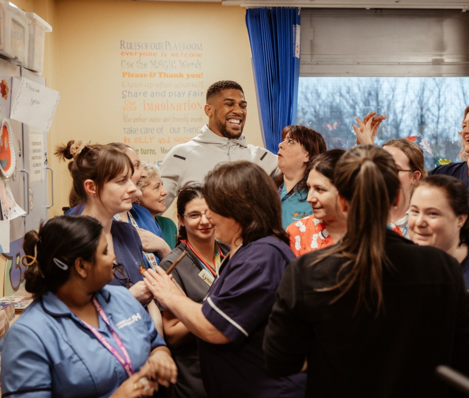 Anthony Joshua visiting a children's hospital ward.