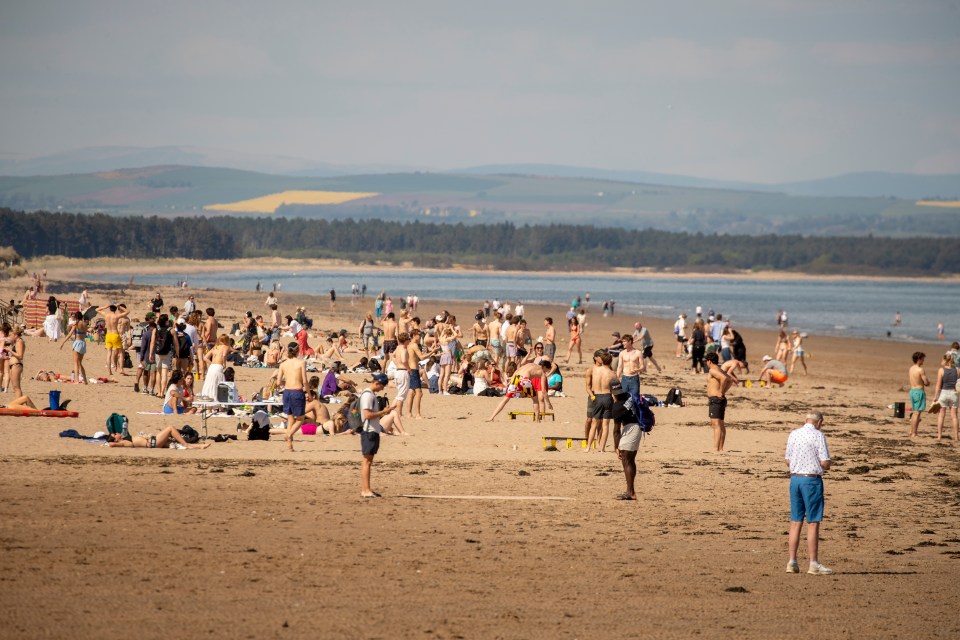 Crowded beach scene in St Andrews.