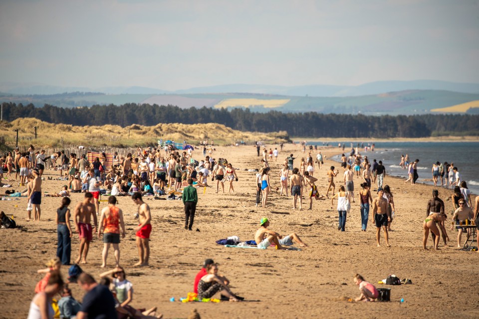 Crowded beach in St. Andrews on a hot day.