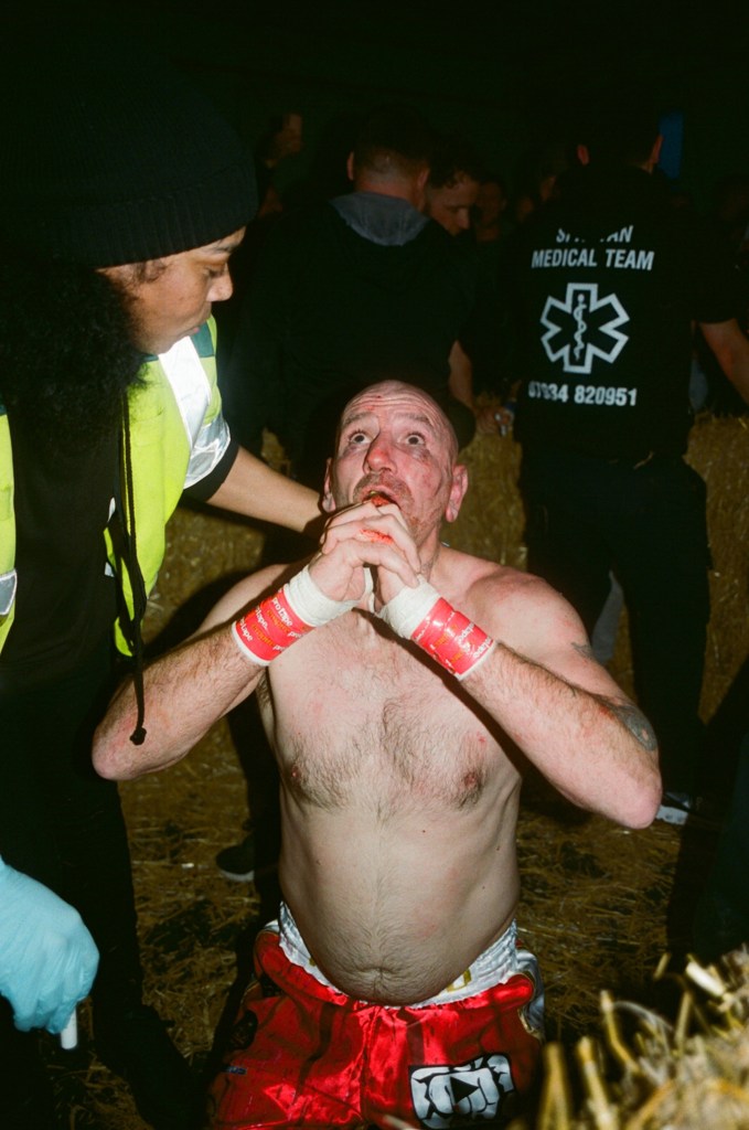 A fighter prays to the ceiling