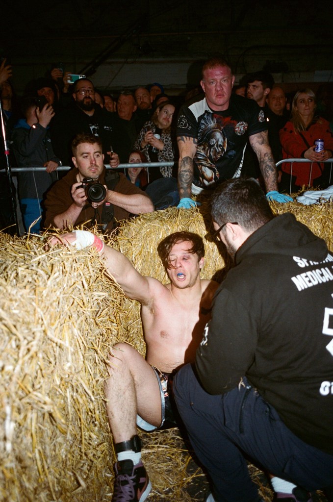 A fighter recovers in the corner of the ring