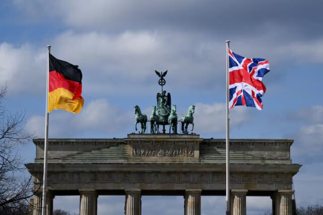 A German and a Union Jack flag fly at Brandenburg Gate, in Berlin, Germany, March 29, 2023. REUTERS/Annegret Hilse/File Photo