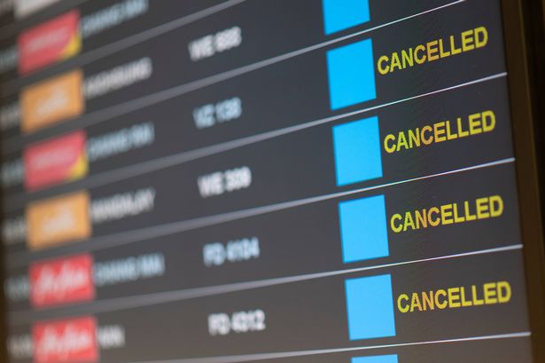 Departure flight board with cancellation at the Airport.