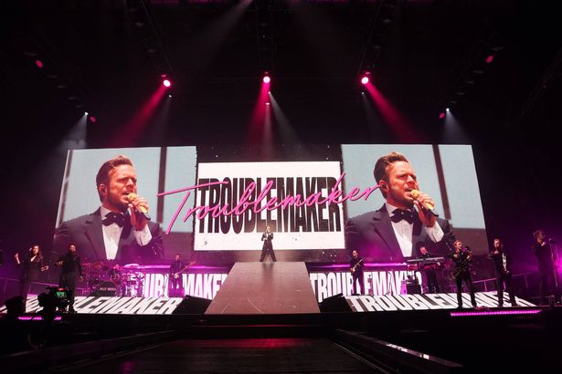 Olly arriving on stage to sing Troublemaker