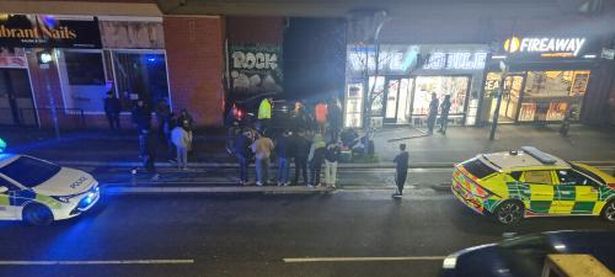 A crowd gathered as crews worked at the scene