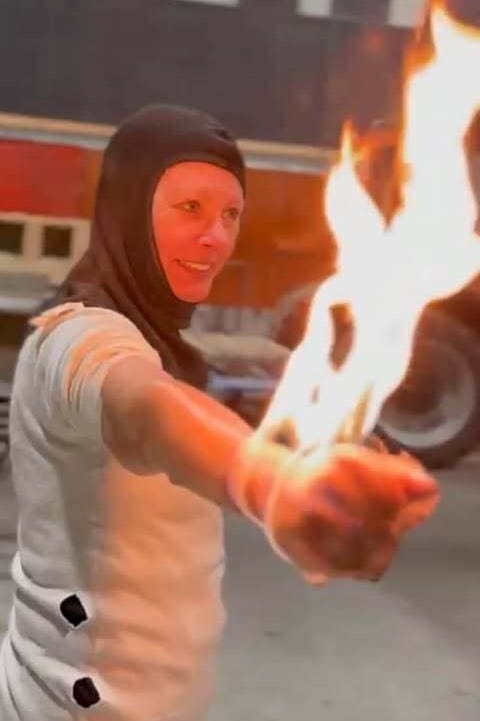 a person holding a flaming object in an indoor environment