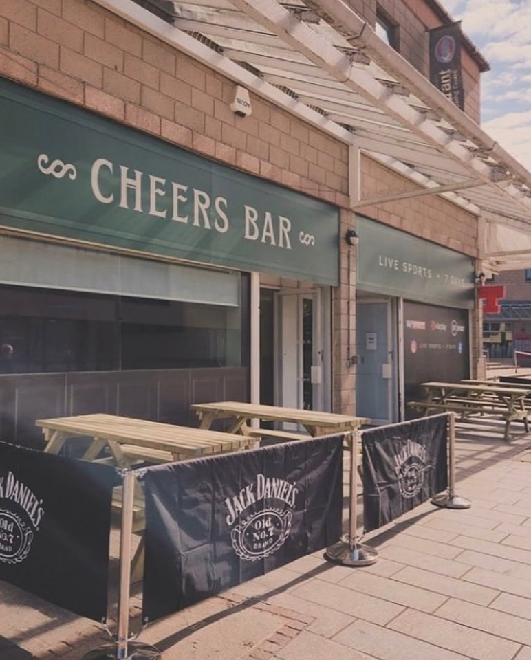 Cheers Bar exterior with outdoor seating.
