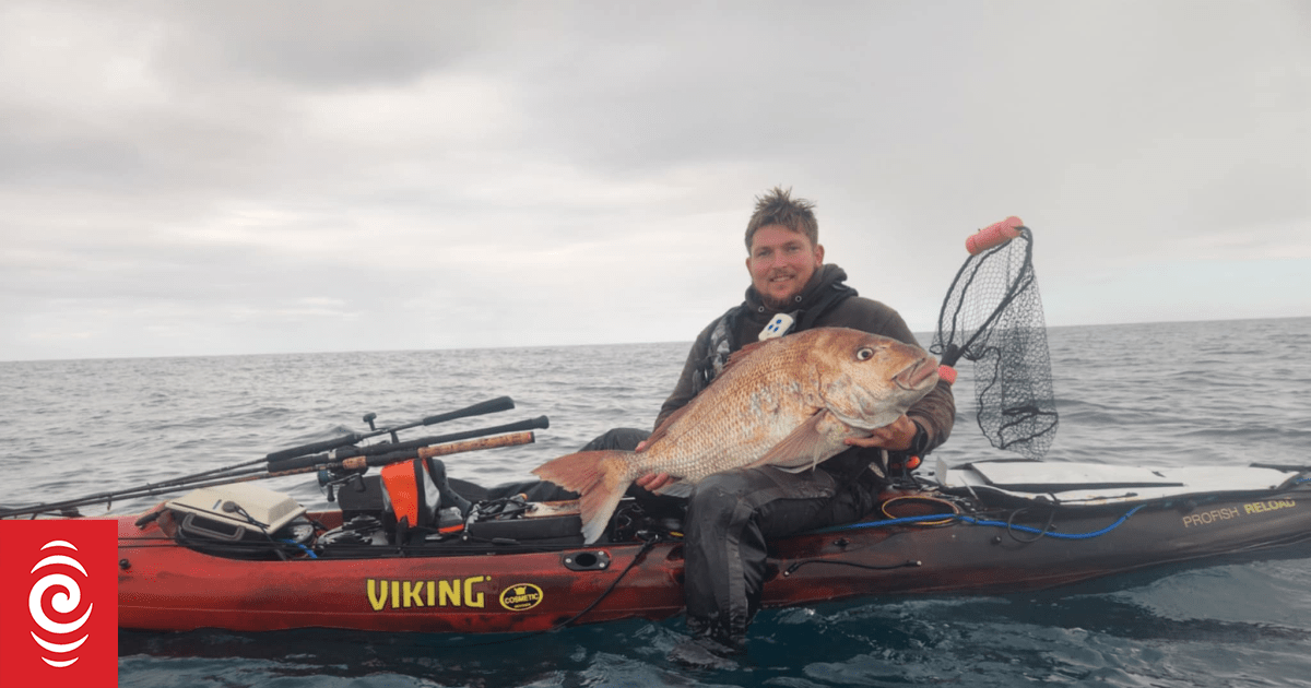 Kayak fisher brushes off sharks to land monster snapper